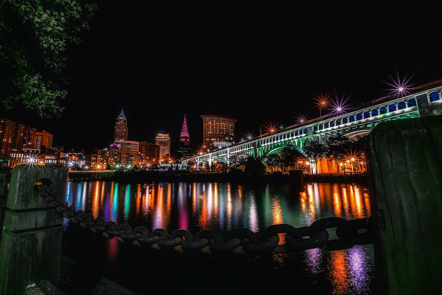 reflection of illuminated buildings in water at night
