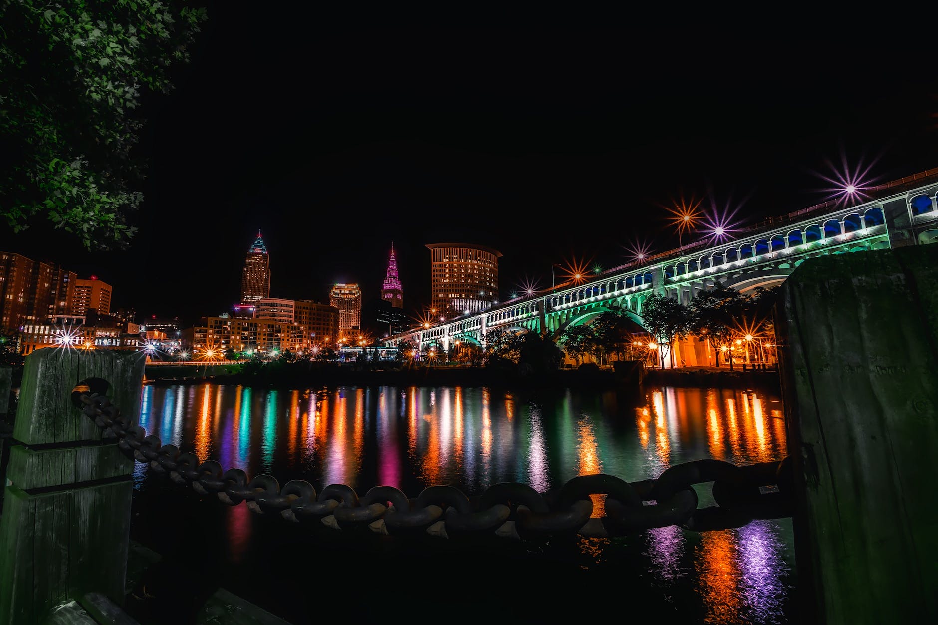 reflection of illuminated buildings in water at night