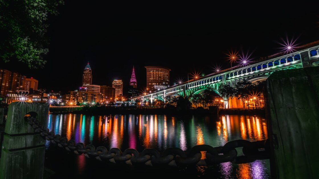 reflection of illuminated buildings in water at night