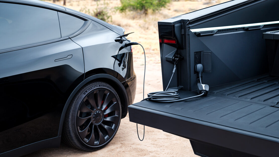 A Tesla Cybertruck charging a Tesla Model Y.