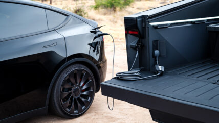 A Tesla Cybertruck charging a Tesla Model Y.